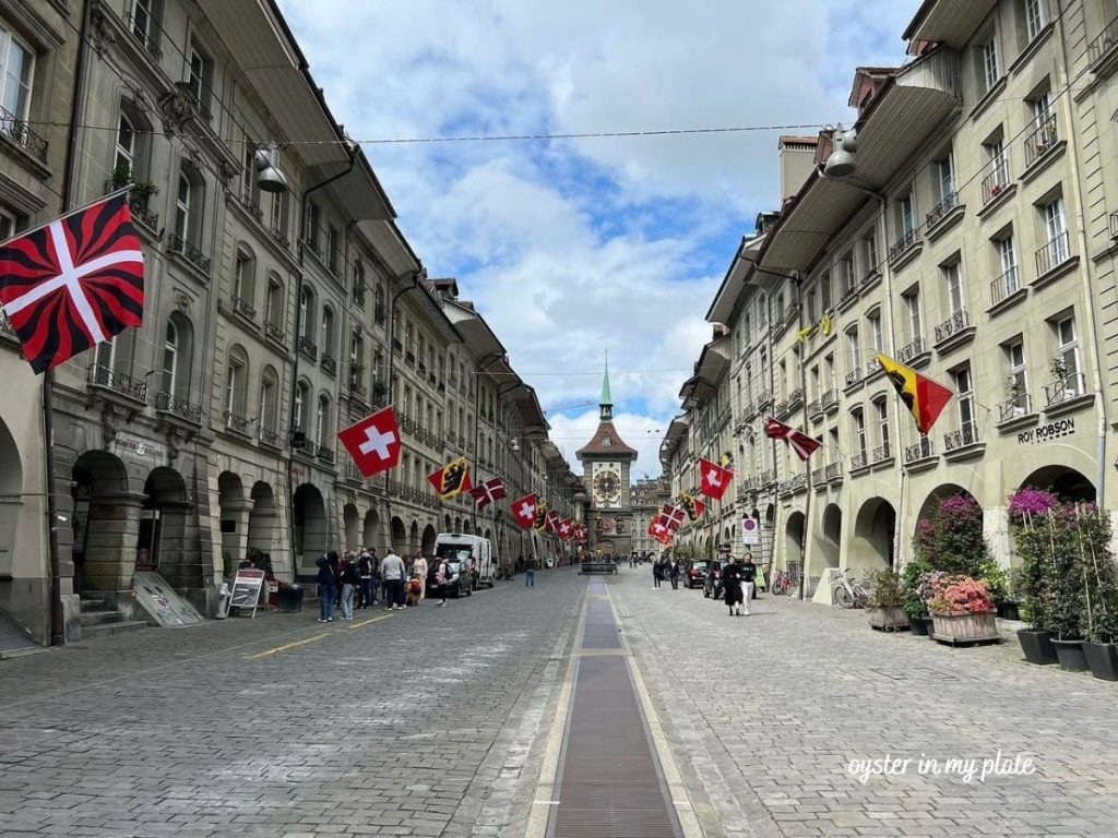 베른 구시가지와 함께 보이는 시계탑, 스위스 베른의 역사적인 상징물로, 고풍스러운 디자인과 함께 도시 중심에 위치한 모습.